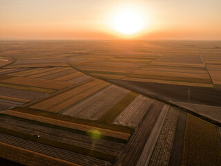 Warm sunlight baths the geometric farmland patterns in a tranquil rural landscape © oticki