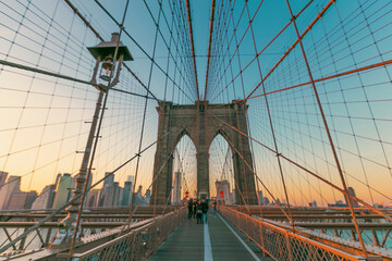 beautiful sunset over manhattan with manhattan and brooklyn bridge.  Brooklyn Bridge illuminate at...