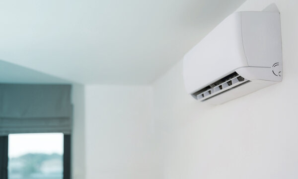Modern air conditioner unit on a white wall