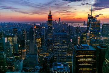 New York Manhattan view from One World Trade Center. sunset view with financial buildings city light. Empire State building on sunset  - obrazy, fototapety, plakaty