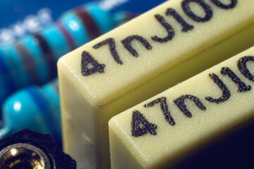 Ultra detailed shot of polyester film capacitors mounted on a PCB, shallow focus