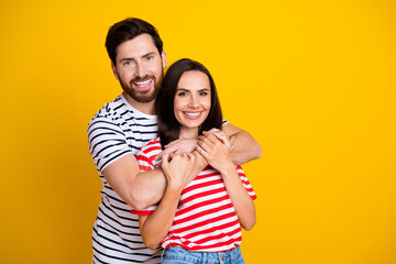 Fototapeta premium Photo portrait of nice young couple hugging support each other wear trendy striped outfit isolated on yellow color background
