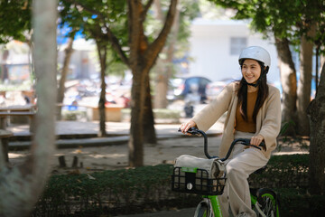 Asian businesswoman go to work at office stand and smiling wear backpack with bicycle. Bike commuting, Commute on bike, Business commuter concept.