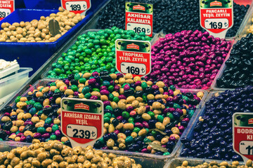 Assorted multicolored olives on display at Egypt Bazaar in Istanbul, with vivid colors and price...