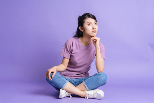 Photo of young Asian girl on purple background
