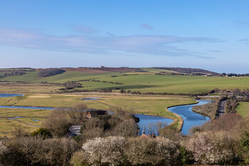 A view over the Cuckmere River in Sussex, with a blue sky overhead