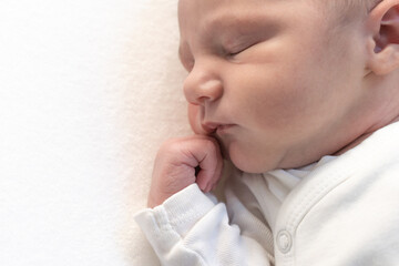 Sleeping newborn baby on white blanket banner. Beautiful portrait of little child close-up. High quality photo