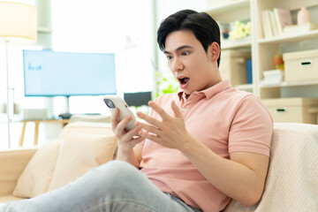 Photo of young Asian man at home