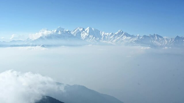 Time lapse of clouds moving into the vast himalayan mountin valley in front of the mountains of Ganesh Himal. Nepal