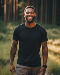 Male model posing outdoors with plain blank black canvas t-shirt mockup