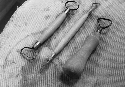 Pottery Tools On Textured Fabric In Black And White