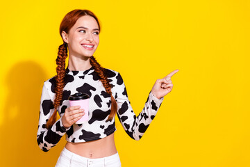 Photo of sweet dreamy lady dressed cowskin print top enjoying milk showing finger empty space...