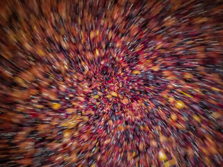 Intentional spiral blur effect with vibrant colorful with light from grape skin, textured background