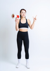 Young Asian woman wearing sportswear on white background