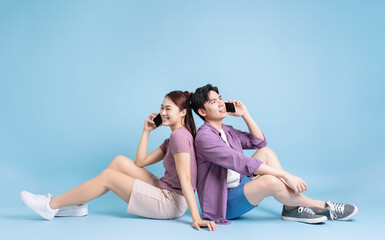 Obraz premium Young Asian couple on blue background