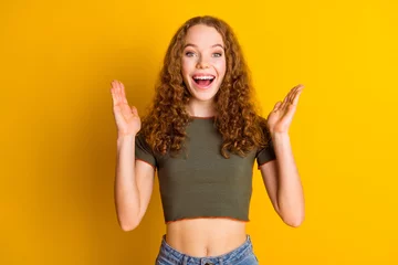Türaufkleber Photo of overjoyed glad girl wear trendy clothes applause celebrate luck fortune victory isolated on vivid yellow color background © deagreez