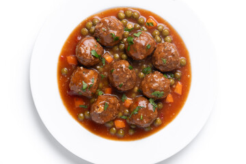 Meatballs, green peas and carrot with tomato sauce isolated on white background. Top view