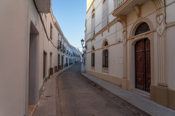 Fototapeta na wymiar Streets of the beautiful village of Olivenza with its white typical houses at sunset. Badajoz, Extremadura, Spain