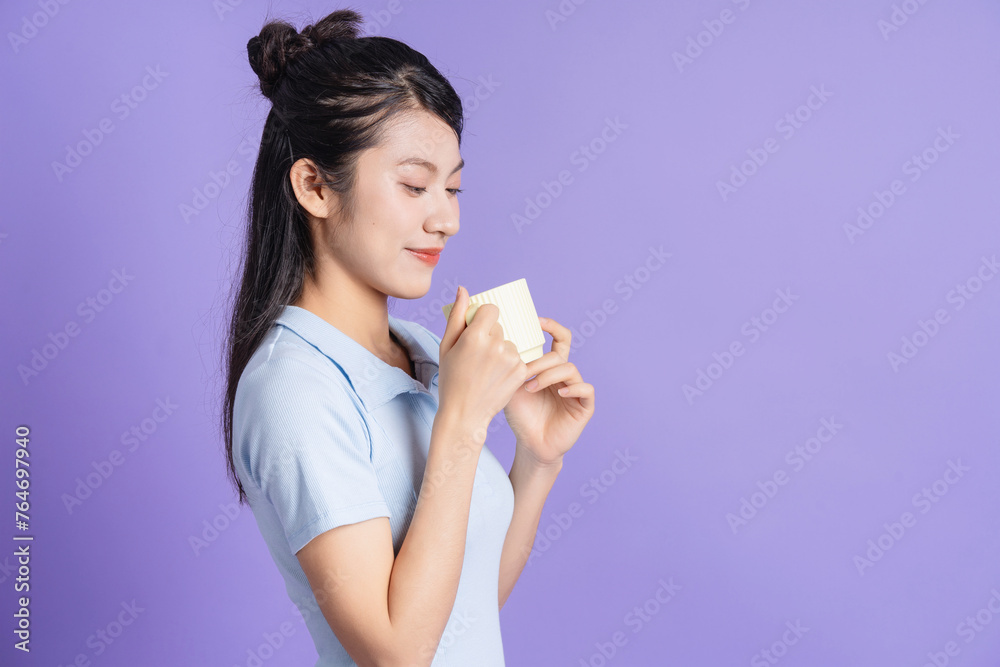 Canvas Prints Photo of young Asian girl on purple background