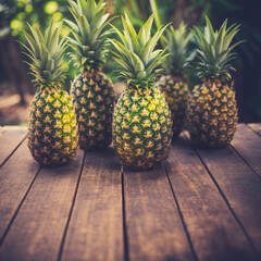 A wooden table showcases pineapples, a tropical fruit. These naturally delicious and healthy fruits are a delightful treat. Healthy food background with copy space - 764698508