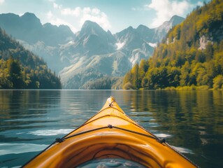 The front of a kayak on a lake with forested mountains in the background - obrazy, fototapety, plakaty