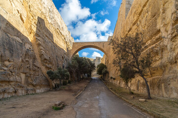 Valletta, Malta - December 13th 2020: A road running through the Valletta Great Ditch in between St...