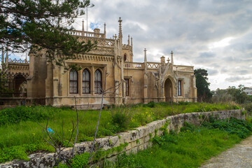 Fototapeta premium Paola, Malta - January 28th 2022: One of the Gatehouse’s at the entrance of the Santa Maria Addolorata Cemetery also known as the Addolorata Cemetery. 