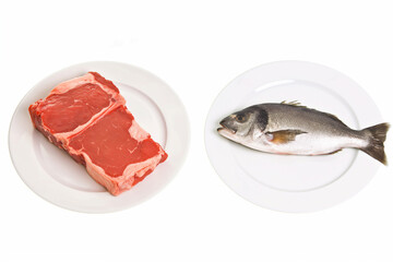 A piece of raw meat and a fish are placed on separate white plates