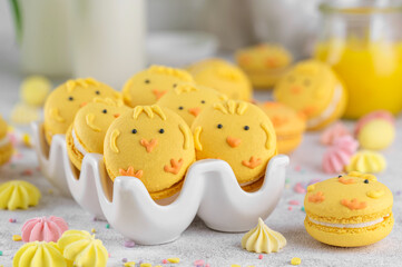 Cute Easter chick macarons. French macarons with vanilla cream and lemon curd on a concrete background. Funny food idea. Copy space.