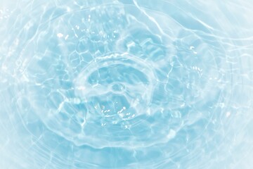 Fototapeta na wymiar Bluewater waves on the surface ripples blurred. Defocus blurred transparent blue colored clear calm water surface texture with splash and bubbles. Water waves with shining pattern texture background. 