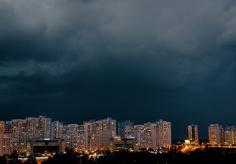 Dramatic stormy dark cloudy sky over row of typical residential district. - 764719791
