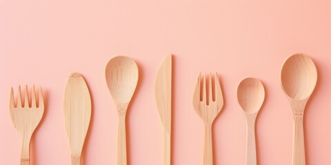 A group of compostable wooden cutlery against a pink background, highlighting sustainable options for single-use items in catering and events.