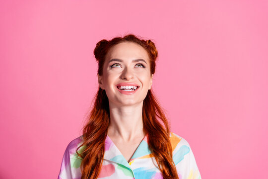 Photo of gorgeous funny girl with redhair tails dressed colorful blouse look up at logo empty space isolated on pink color background