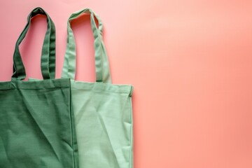 A single green recycled fabric tote on the left against a pink background for eco-friendly shopping promotions and fashion accessories advertising.