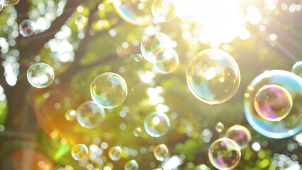 Soap bubbles fly in the air against the background of green foliage.