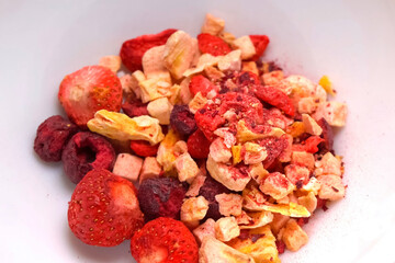 Freeze dried fruits, strawberries, raspberries and others in a plate.