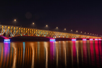 Fototapeta na wymiar Bridge of the Legions of Josef Pilsudski at night with colorful lighting. Plock, Poland