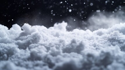 A close-up view of fresh fluffy snow with sparkling snowflakes falling in the background.