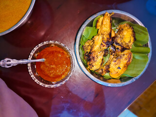 several pieces of grilled chicken in a stainless steel bowl