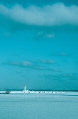 Vorontsov Lighthouse near Odessa in the Black Sea. Blue Sky background with white clouds. White Lighthouse.