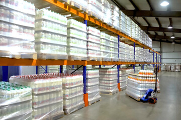 Large warehouse with goods on shelves of racks.
