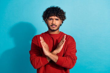 Photo of serious handsome guy crossed arm demonstrate stop enough symbol empty space isolated on...