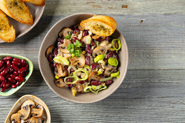Spring salad with red beans and mushrooms. Served with croutons and garlic butter.