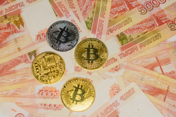 Bitcoin on banknotes with a face value of five thousand Russian rubles. The BTC cryptocurrency.