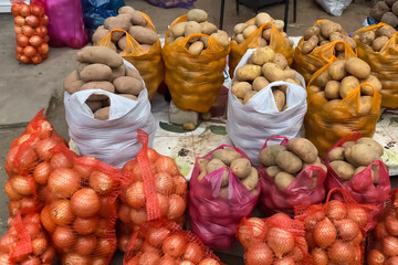 Potatoes in bags and in net. Packaged potatoes on the counter