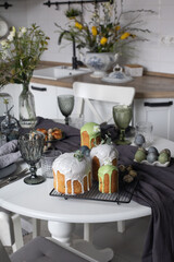 Stylish decorated table with eggs and plates for Easter dinner