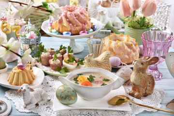 Easter table with traditional white borscht, sausage with horseradish and pastries