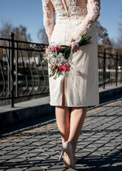 The bride holds a bouquet flowers