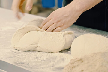 Rolling out dough with your hands, flour and white dough.
