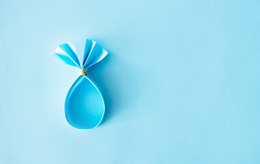 Easter bunny paper egg wrapping diy idea. Minimal easter concept with copy space.
